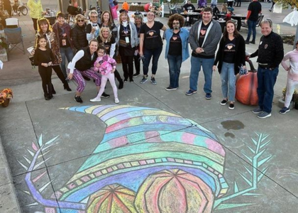 Anderson Art Collaborative group in front of sidewalk chalk art